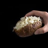Make these quick & easy Pressure Cooker Potatoes in 25 minutes! Shortcut to make Oven Baked Potatoes with a slight crisp skin. Cuts cooking time in half!