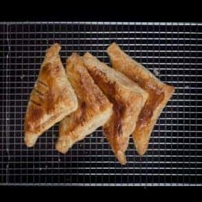 Easy Apple Turnovers Recipe - make these with only 4 ingredientsEasy Apple Turnovers Recipe (Only 4 Ingredients & 10-mins prep)! Flaky & crisp buttery puff pastry, bursting with warm cinnamon-spiced applesauce. Perfect Autumn desserts.