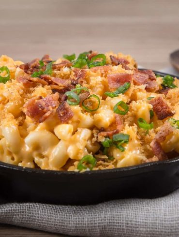 Loaded Instant Pot Mac and Cheese Recipe: Piping hot elbow macaroni swimming in creamy cheddar cheese sauce. Sprinkled with buttery toasted golden breadcrumbs, smoky crispy bacon bits, and crunchy scallions. Indulge in this ultimate kid-friendly comfort food.