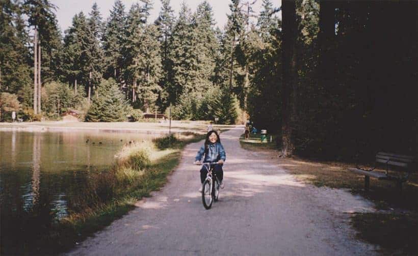 Amy riding a bike in the park.