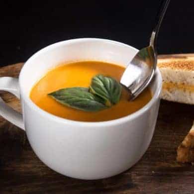 Make this Delicious Creamy Comfort: Instant Pot Tomato Soup Recipe (Pressure Cooker Tomato Soup)! This homemade tomato basil soup from scratch (with vegan option) is healthy, super easy to make, and freezer-friendly. Perfect dip for the toasted golden grilled cheese.