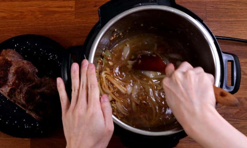 Deglaze Instant Pot with wooden spoon  #AmyJacky #InstantPot #PressureCooker #recipe