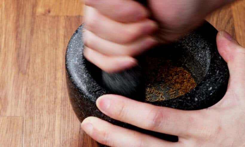 crush whole cumin seeds with mortar and pestle