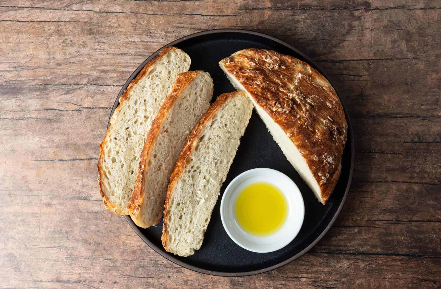 Fresh Bread Covered With A Checkered Towel On A Rustic Kitchen